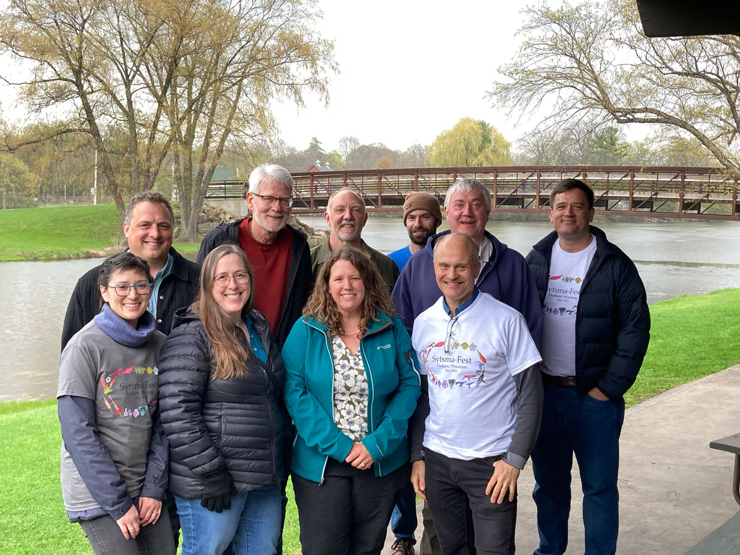 Alumni Members of the Sytsma lab pose for a photo in a park on an overcast day