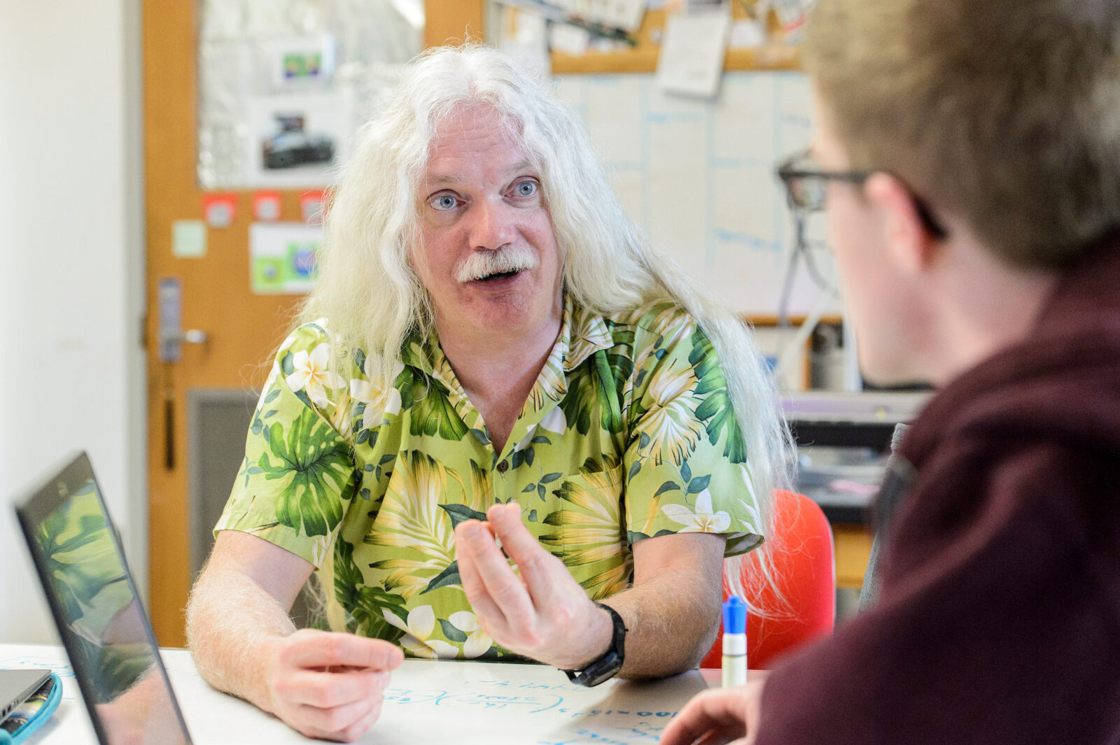 Portrait of Professor Simon Gilroy discussing with a student.
