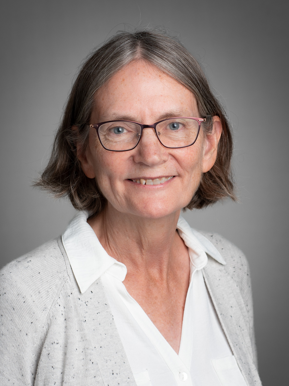 Portrait of Mary Halloran on a grey studio backdrop